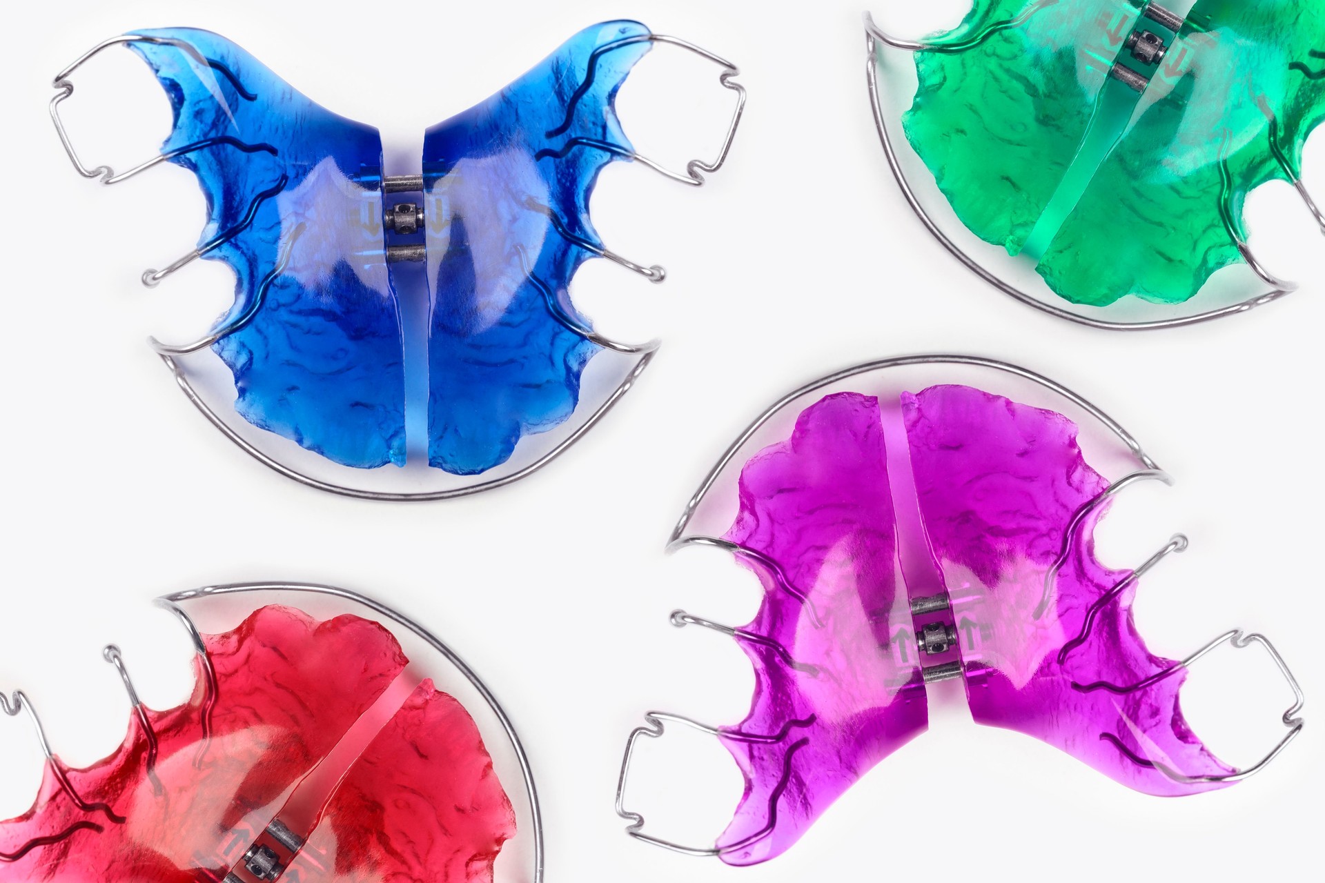 Close-up of children's orthodontic appliances in bright, fun colours